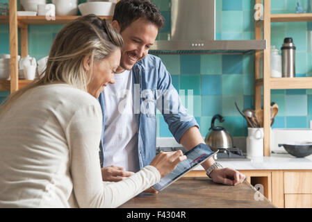 Couple using digital tablet at home Stock Photo
