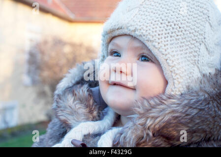 Baby wearing knit hat outdoors, portrait Stock Photo