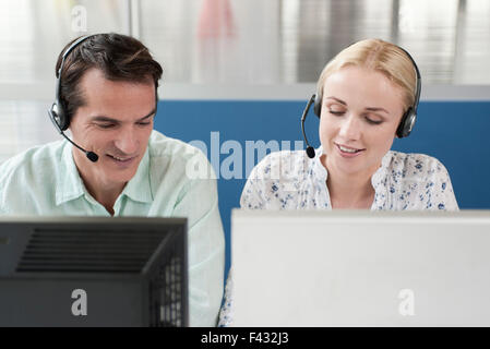 Telemarketers working in call center Stock Photo