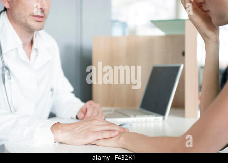 Doctor consoling patient after delivering bad news, cropped Stock Photo