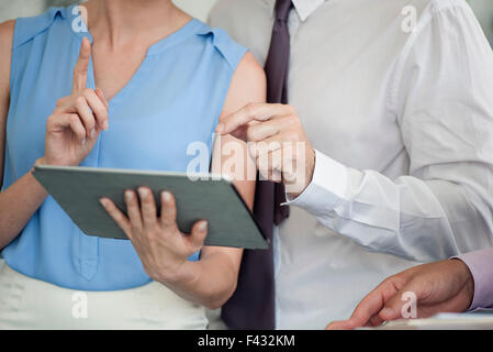 Business colleagues working together with digital tablet, cropped Stock Photo