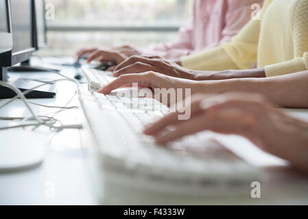 Professionals using desktop computers in training class, cropped Stock Photo