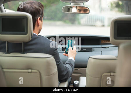 Using smartphone while driving Stock Photo