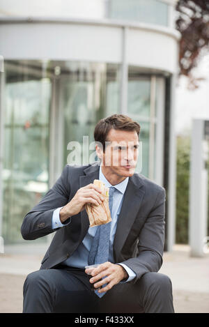 Businessman having lunch outdoors Stock Photo