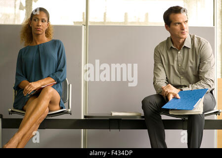 Professionals sitting in waiting room Stock Photo