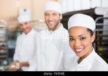 Team of bakers smiling at camera Stock Photo