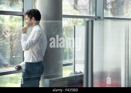 Man using phone during work break Stock Photo