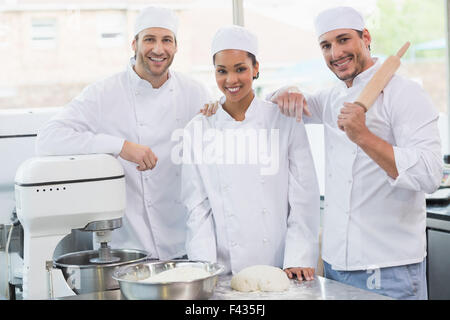 Team of bakers smiling at camera Stock Photo