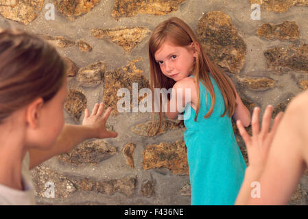 Girl playing tag with friends Stock Photo