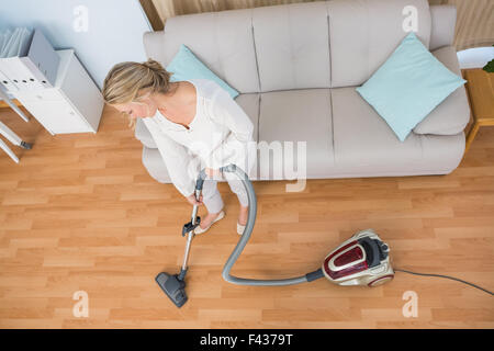 Disinterest woman cleaning her living room Stock Photo