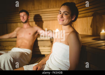 Happy couple enjoying the sauna together Stock Photo
