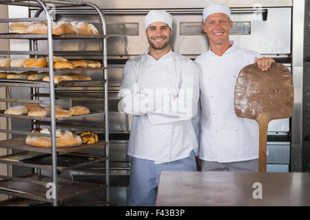 Team of bakers smiling at camera Stock Photo