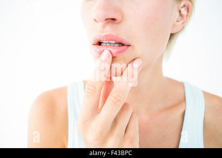 Thoughtful woman touching her lips Stock Photo