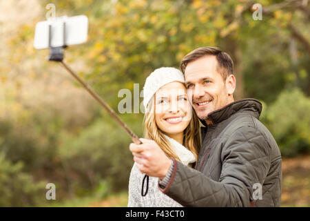 Smiling young couple taking selfies Stock Photo