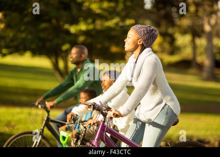 Side view of a young family doing a bike ride Stock Photo