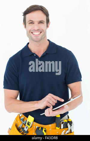 Happy handyman using digital table Stock Photo