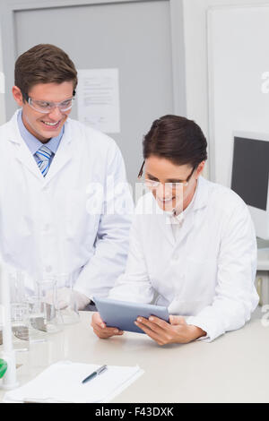 Smiling scientists using tablet Stock Photo