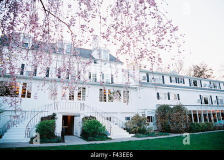 An elegant late 18th century mansion, facade with terrace and stairs overlooking a formal garden. A hotel and restaurant. Stock Photo