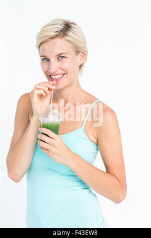 Beautiful woman drinking green juice Stock Photo