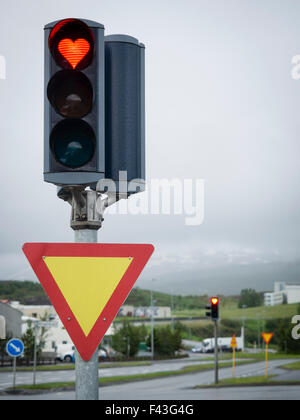 A traffic signal on the roadside, a heart shaped red light. Stock Photo