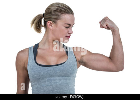 Beautiful strong muscular woman flexing her biceps and arm muscles. Stock  Photo by ©yobro10 147024447