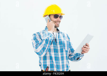 Carpenter using digital tablet and cellphone Stock Photo