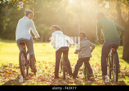 Rear view of a young family doing a bike ride Stock Photo