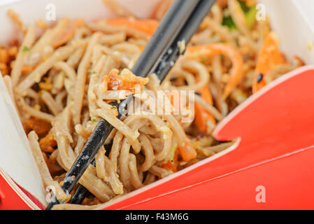 Noodles in red take away container Stock Photo