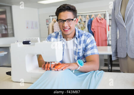 Fashion student using sewing machine Stock Photo