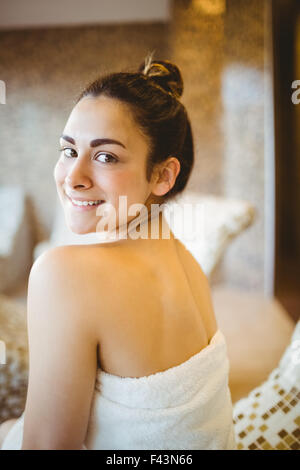 Woman sitting down wearing a towel Stock Photo