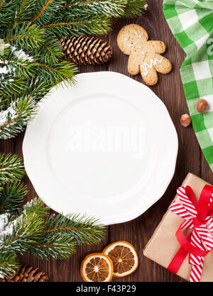 Christmas tree branch, empty plate and coffee. Top view with copy space Stock Photo