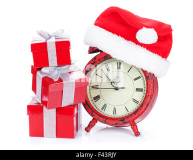Christmas clock, gift boxes and santa hat. Isolated on white background Stock Photo