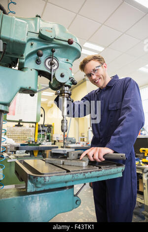 Engineering student using large drill Stock Photo