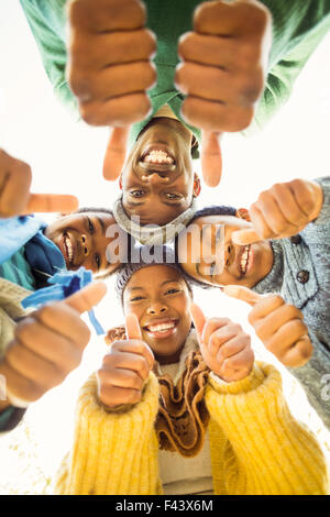 Young family doing a head circles with thumbs up Stock Photo