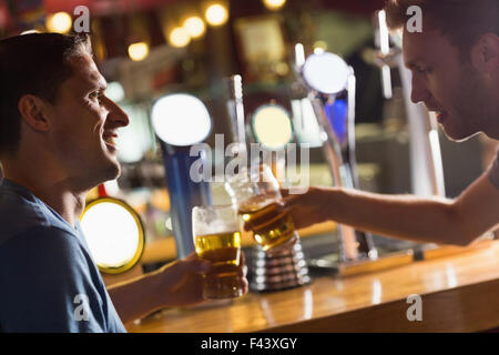 Happy friends catching up over pints Stock Photo