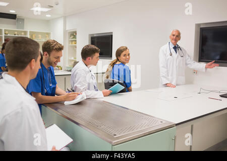 Medical professor teaching young students Stock Photo
