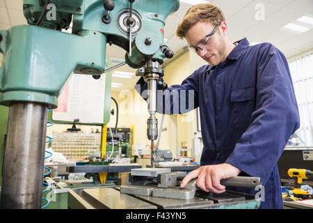 Engineering student using large drill Stock Photo