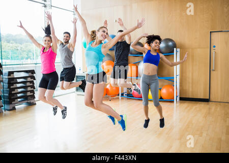 Fitness class jumping up in studio Stock Photo