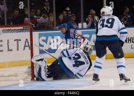 Winnipeg Jets goalie Michael Hutchinson (34) deflects a shot by ...