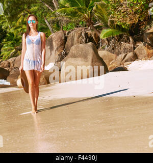 Woman in bikini on beach at Seychelles Stock Photo