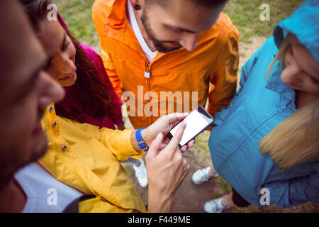 Friends using a smartphone on hike Stock Photo
