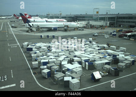 Mass of cargo containers that transport luggage and other cargo to and from airplanes at JFK International Airport in NY City Stock Photo