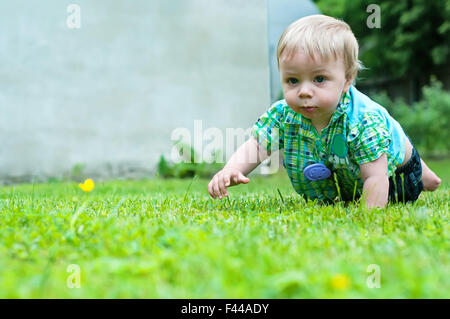 Cute baby crawling in the grass Stock Photo