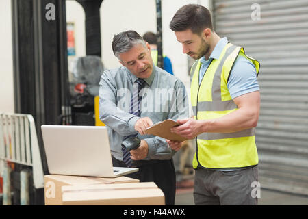 Workers scanning package in warehouse Stock Photo