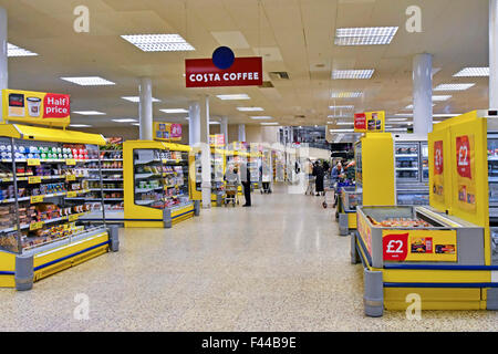 Costa Coffee sign above wide shopping aisle for café facility interior view Tesco Extra supermarket retail business store London England UK Stock Photo