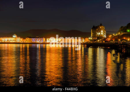 The Grand Hotel by Llandudno Pier with the waterfront holtels on the promeade reflecting in the sea. Stock Photo