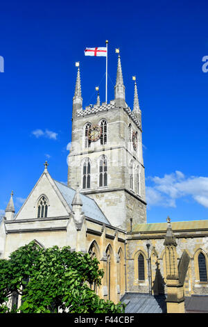 Anglican Southwark Cathedral Tower flying flag of England derived from Saint George's Cross on blue sky day Southwark London England UK Stock Photo
