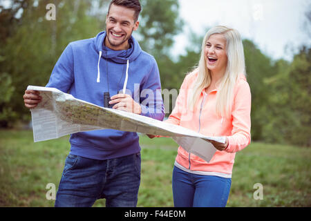 Happy couple reading a map together Stock Photo