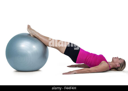 Side view of woman exercising with ball Stock Photo