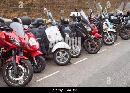 Motorcycles and scooters parked outside Paddington railway station, London England United Kingdom UK Stock Photo